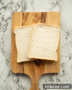 overhead shot of two slices of bread on wooden chopping board