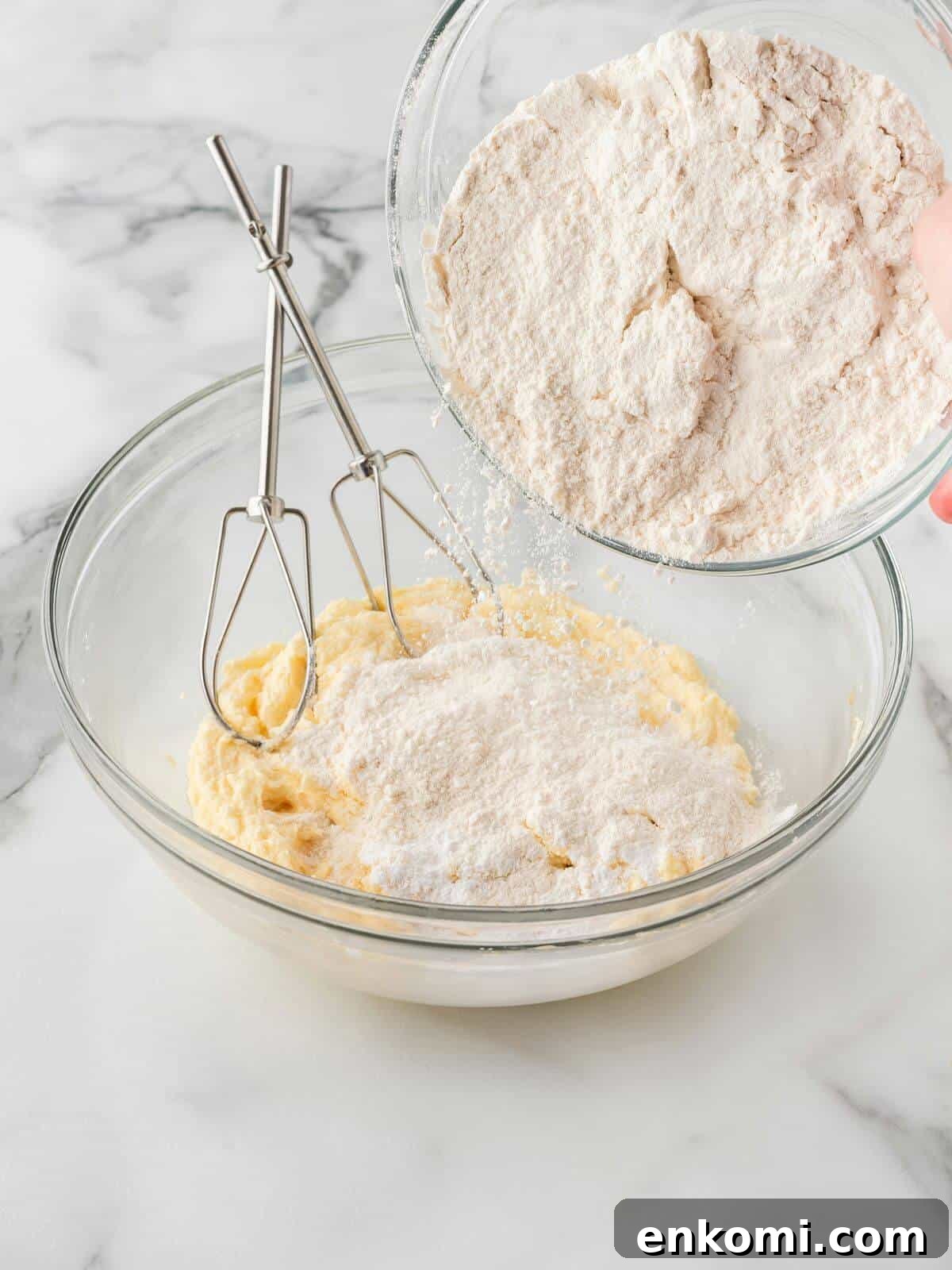 Baseball-Themed Sugar Cookies: Recipes and Decorating Tips 7 pouring flour into wet cookie dough ingredients