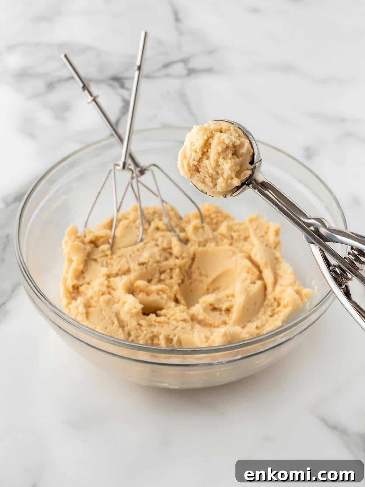 Baseball-Themed Sugar Cookies: Recipes and Decorating Tips 9 raw sugar cookie dough in glass mixing bowl with cookie scoop