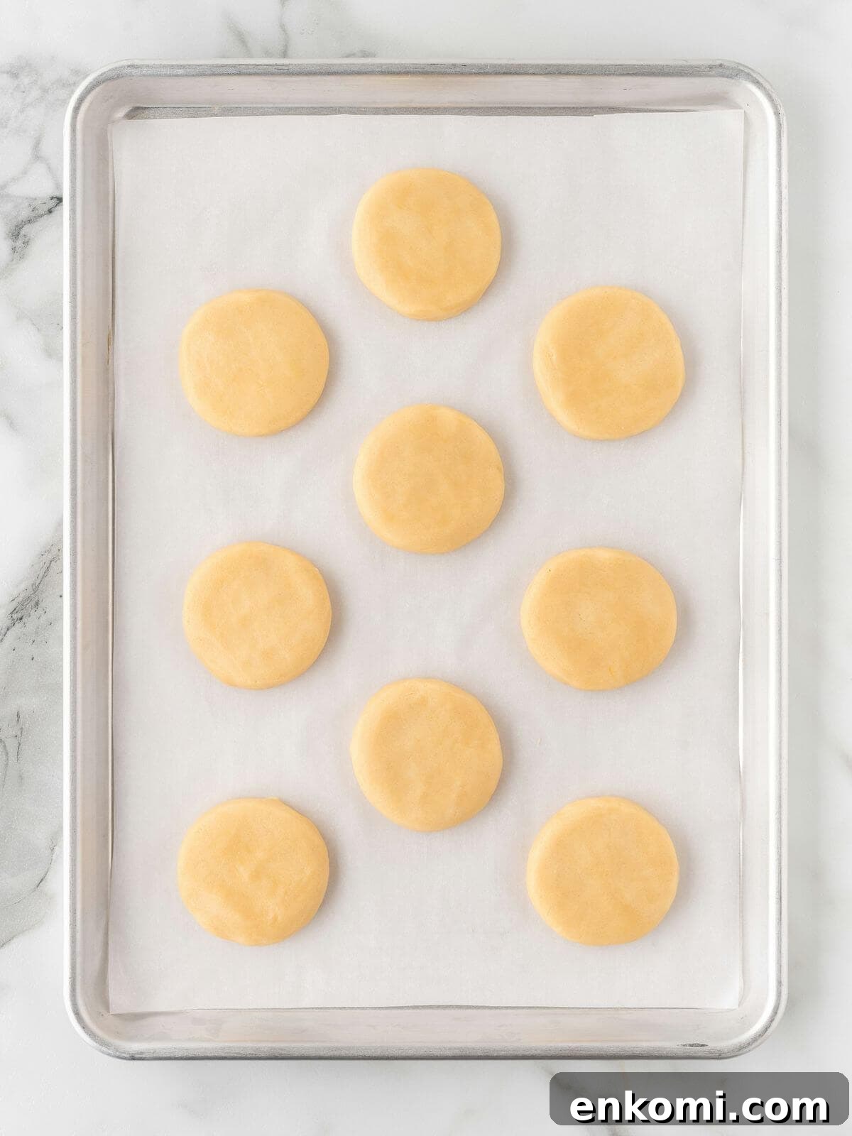 Baseball-Themed Sugar Cookies: Recipes and Decorating Tips 10 baked frosted sugar cookies on parchment lined baking sheet