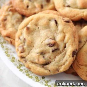 Toll House chocolate chip cookies on white plate.