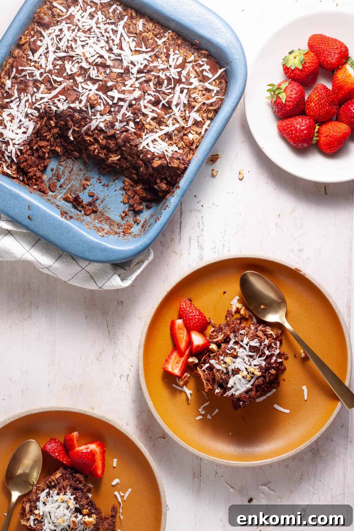 German Chocolate Cake Baked Oatmeal Recipe for Decadent Mornings 2 German chocolate cake baked oatmeal in a baking dish with a couple servings on small plates.