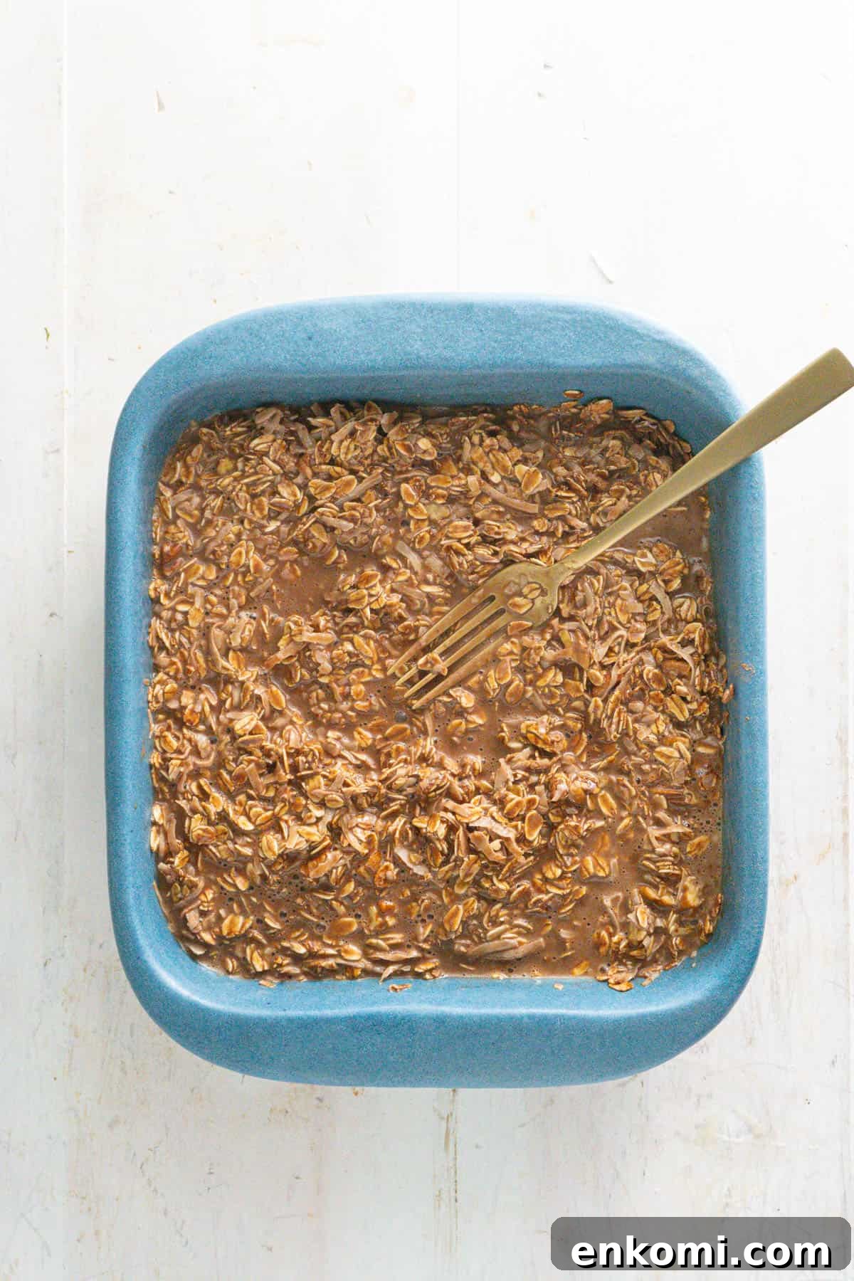 German Chocolate Cake Baked Oatmeal Recipe for Decadent Mornings 6 The wet and dry ingredients of a German chocolate cake baked oatmeal in a baking dish.