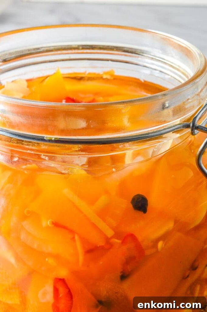 close up of jarred pumpkin pickles with pale grey background