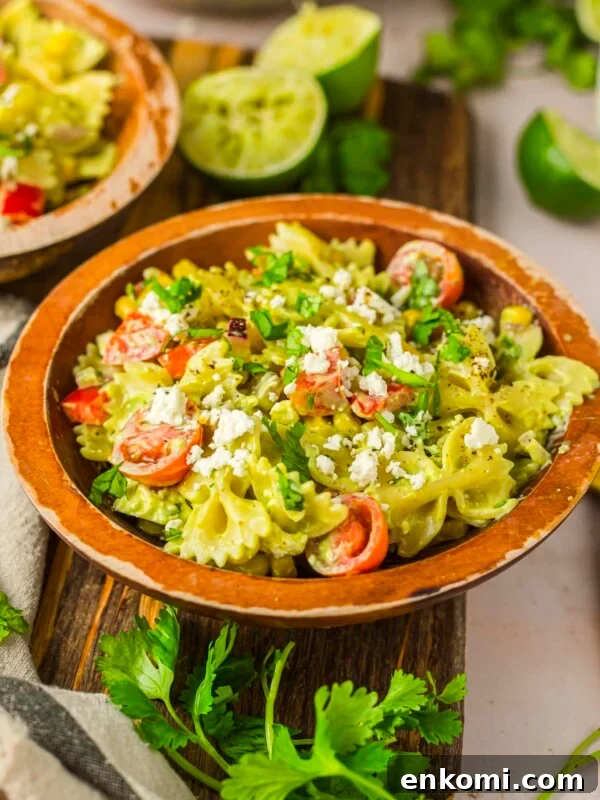 Cilantro lime pasta salad in a wood serving bowl.