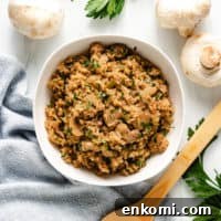 Top down view of rice with mushrooms and garlic.