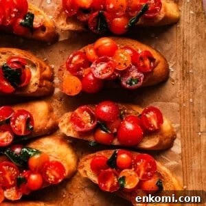 Slices of toasted bread topped with cherry tomatoes and fresh basil.