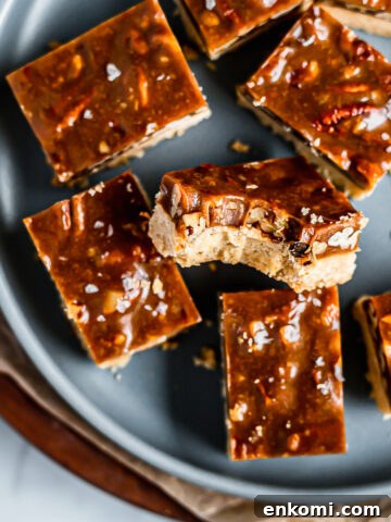 Caramel pecan bars on a blue plate.
