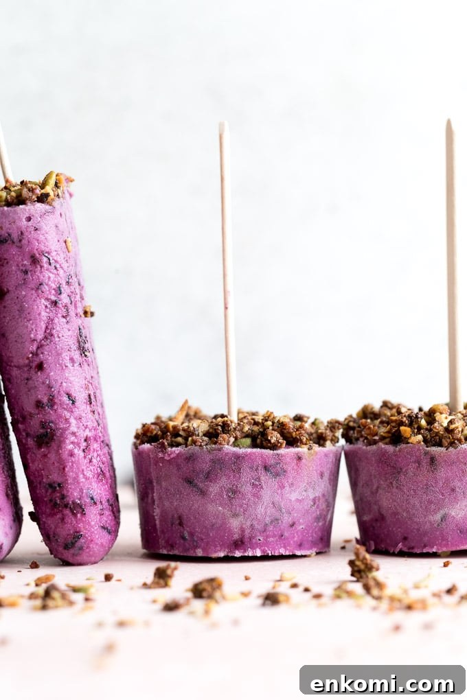 Up-close side view of blueberry goat cheese ice cream bars and cups.