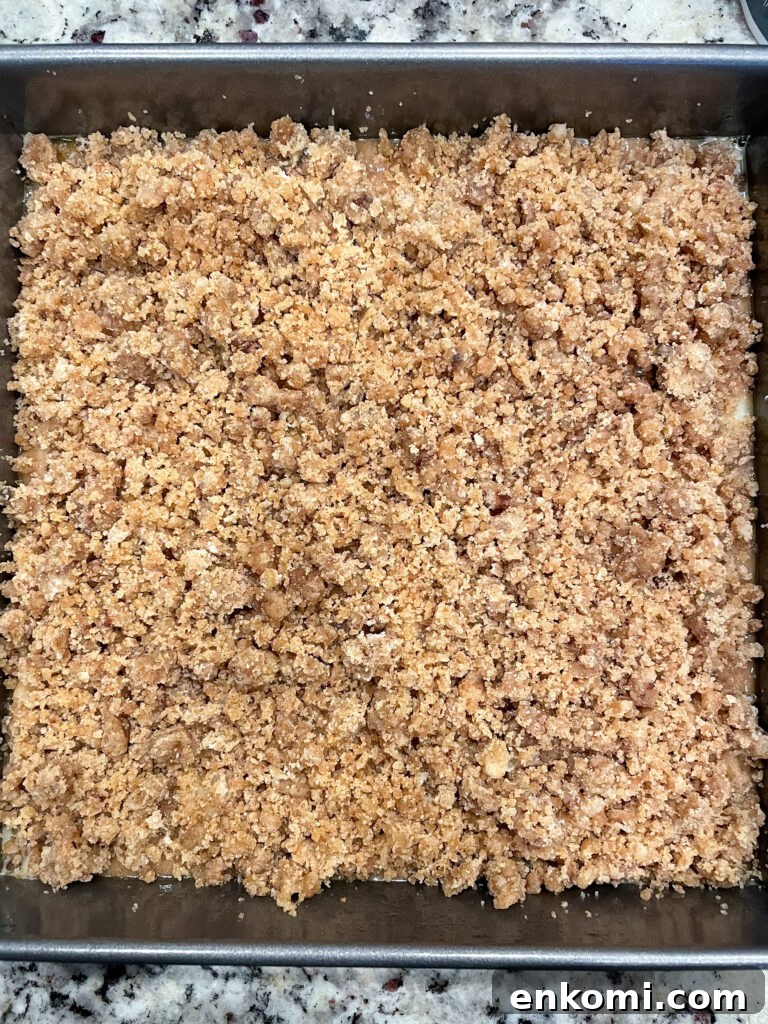 spiced apple crumb cake batter in baking pan ready for the oven. 