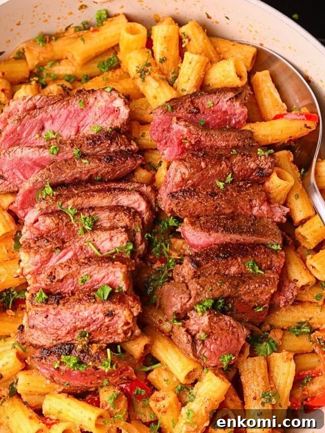 Cowboy butter steak rigatoni in a skillet.