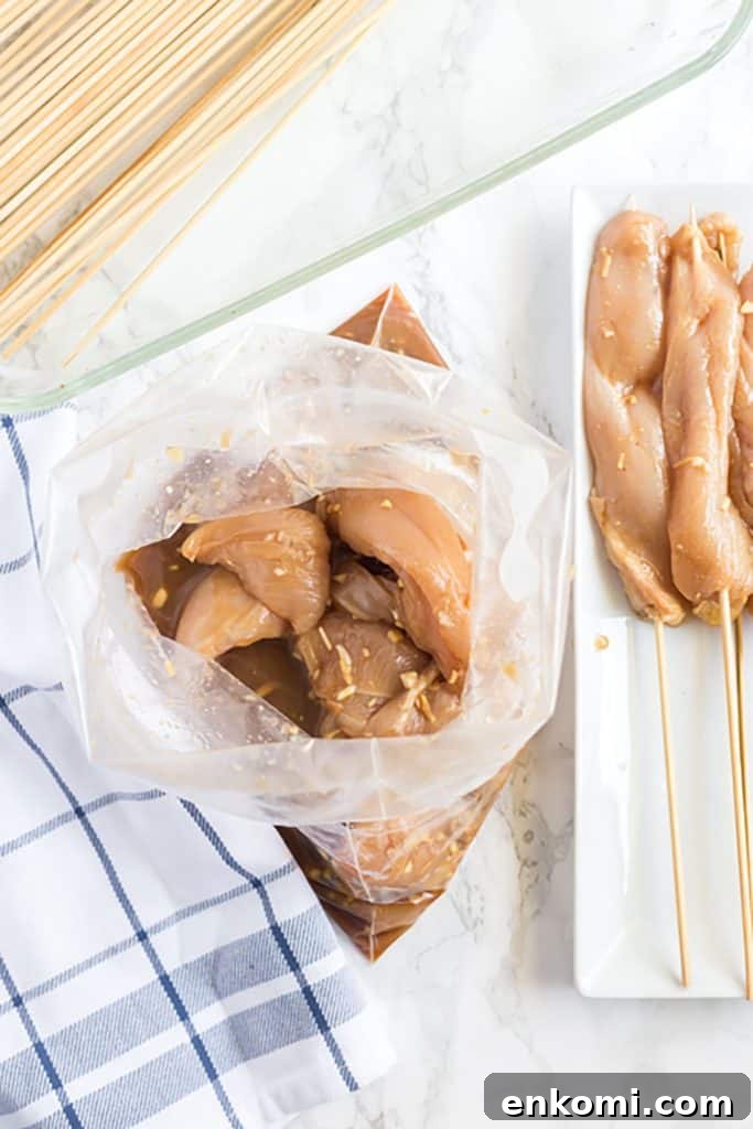 chicken fillets on a resealable bag with asian marinade next to a plate with chicken in skewers