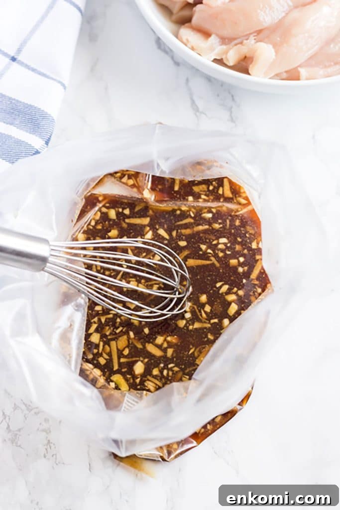 asian marinade ingredients in a resealable bag with a whisk