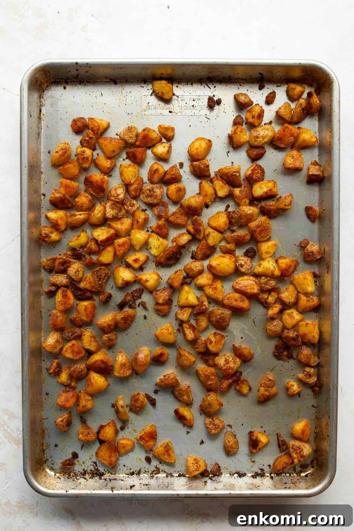 Crispy oven roasted potatoes deep golden brown on a baking sheet after 40 minutes at 425°F.