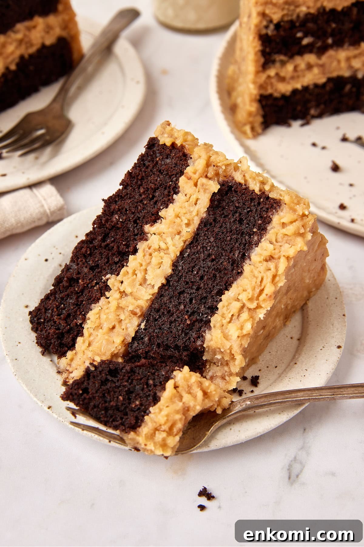 Keto German Chocolate Cake Recipe: Low-Carb Decadent Dessert 5 Plated slice of cake with a fork taking a piece out of the thin edge of the wedge.