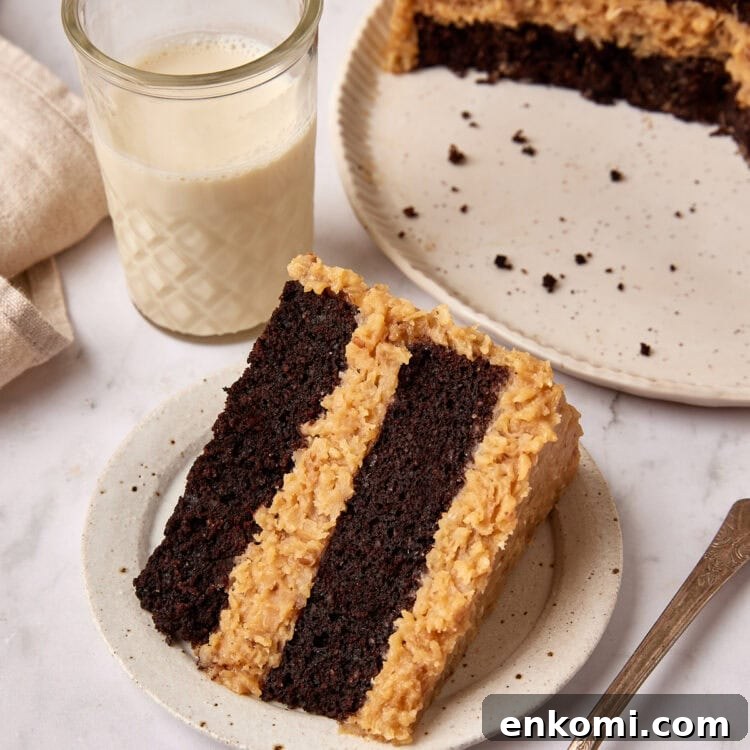 Keto German Chocolate Cake Recipe: Low-Carb Decadent Dessert 7 Slice of German Chocolate cake sits on a small white plate next to a fork.