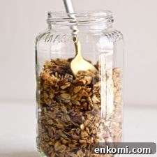 Spoon in a jar of homemade granola.