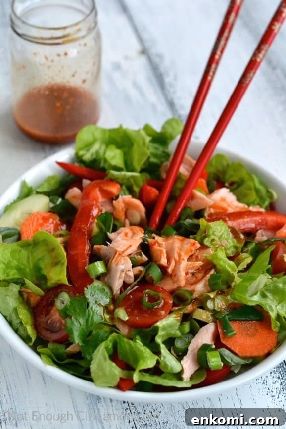 Thai Salmon Salad with Tangy Sweet Chili Dressing 5 Thai Salmon Salad being tossed with Sweet Chili Sauce Dressing using chopsticks