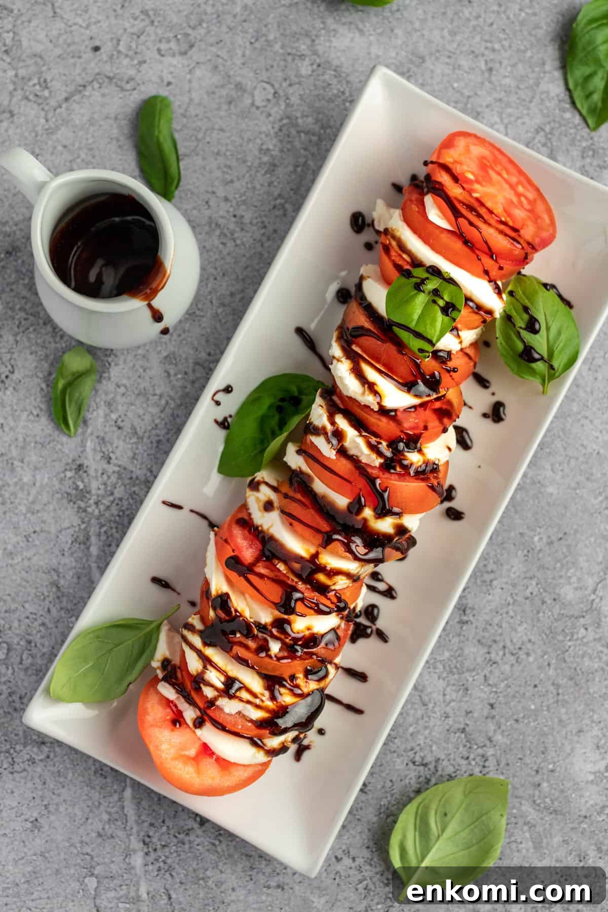 Balsamic Glaze Recipe for Caprese Salad Dressing 2 Overhead view of tomatoes and mozzarella drizzled with balsamic glaze for caprese salad.