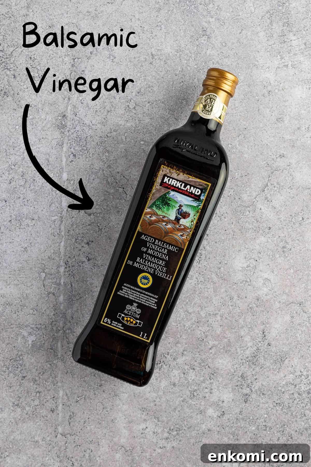 Balsamic Glaze Recipe for Caprese Salad Dressing 3 Overhead view of a jar of balsamic vinegar on a grey marble table.
