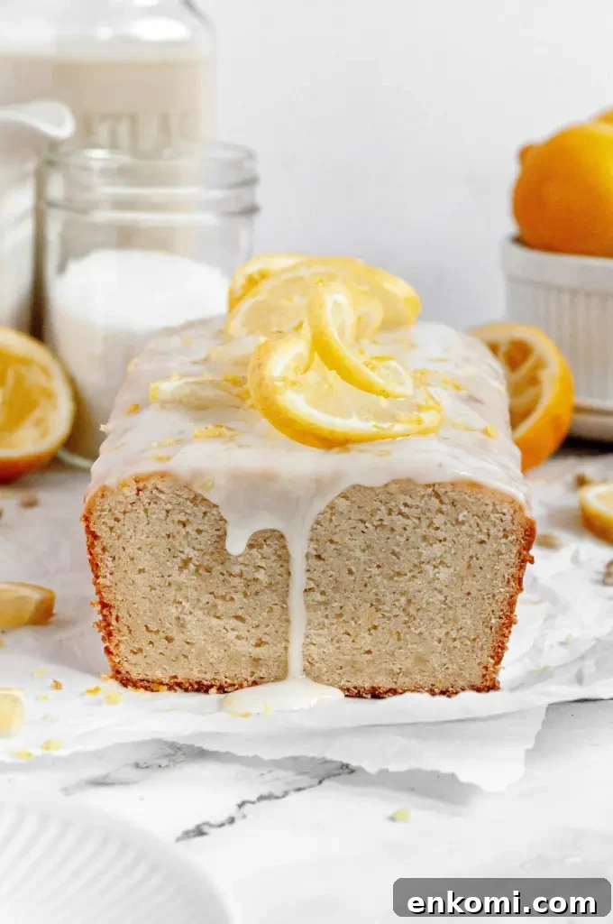 Dairy-Free Cream Cheese Frosting Recipe for Vegan Cakes 7 A light golden yellow lemon pound cake topped with a white lemon glaze and bright yellow lemon slices.