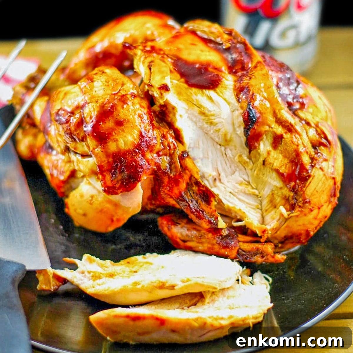 Weight Watchers Potato Salad Recipe — Light & Flavorful 13 Beer butt chicken on a black plate with a couple of slices on plate and beer in background.