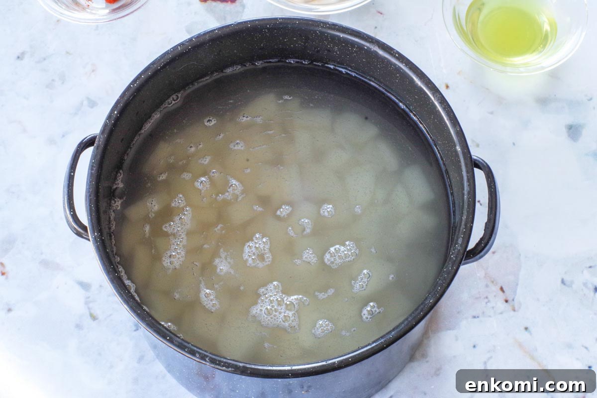 Weight Watchers Potato Salad Recipe — Light & Flavorful 5 Peeled and diced potatoes in a large pot, covered in water.