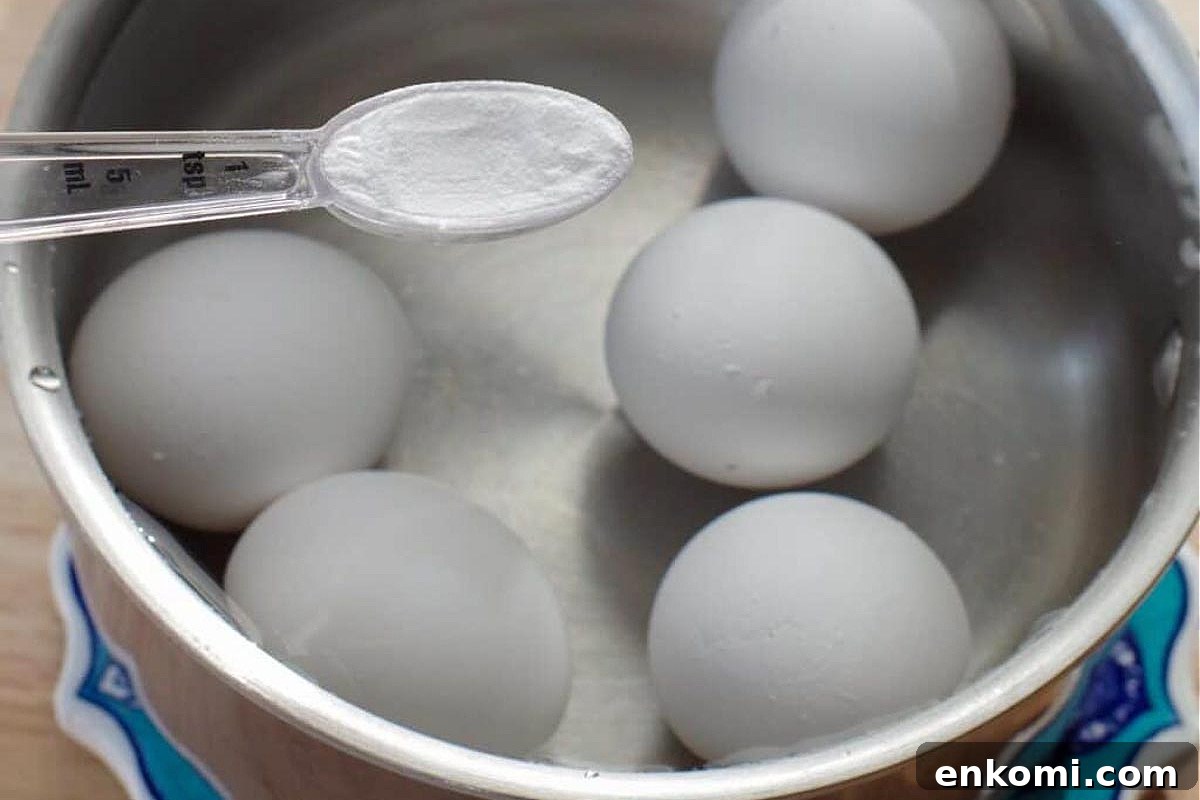Weight Watchers Potato Salad Recipe — Light & Flavorful 7 Eggs being boiled in water with a teaspoon of baking soda in a measuring spoon over the pot.