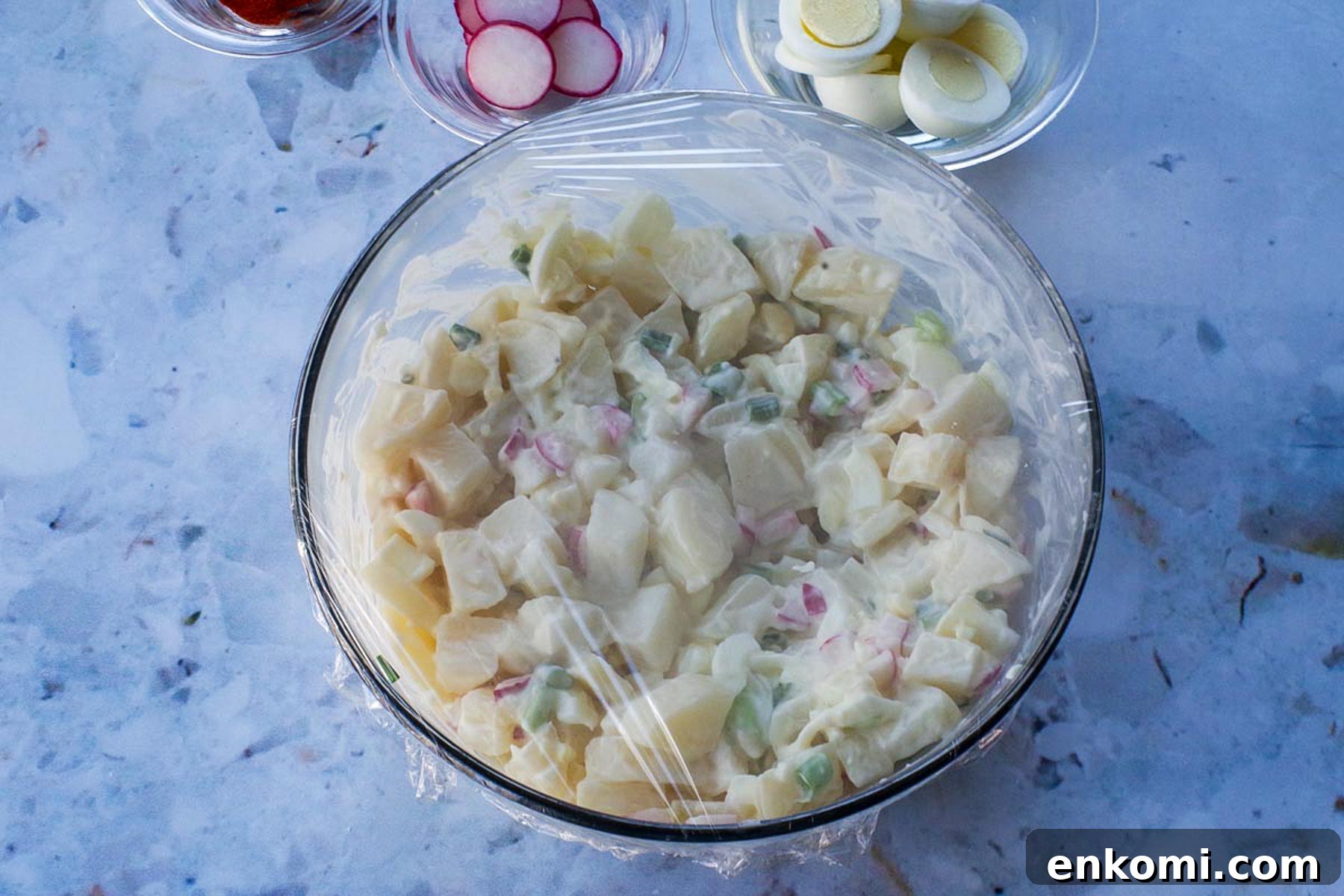 Weight Watchers Potato Salad Recipe — Light & Flavorful 10 Potato salad covered in plastic wrap.