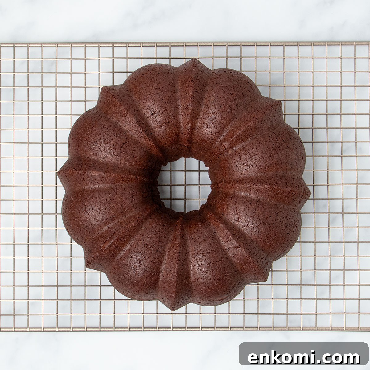 underside of chocolate brown cake overturned onto wire rack, pan removed