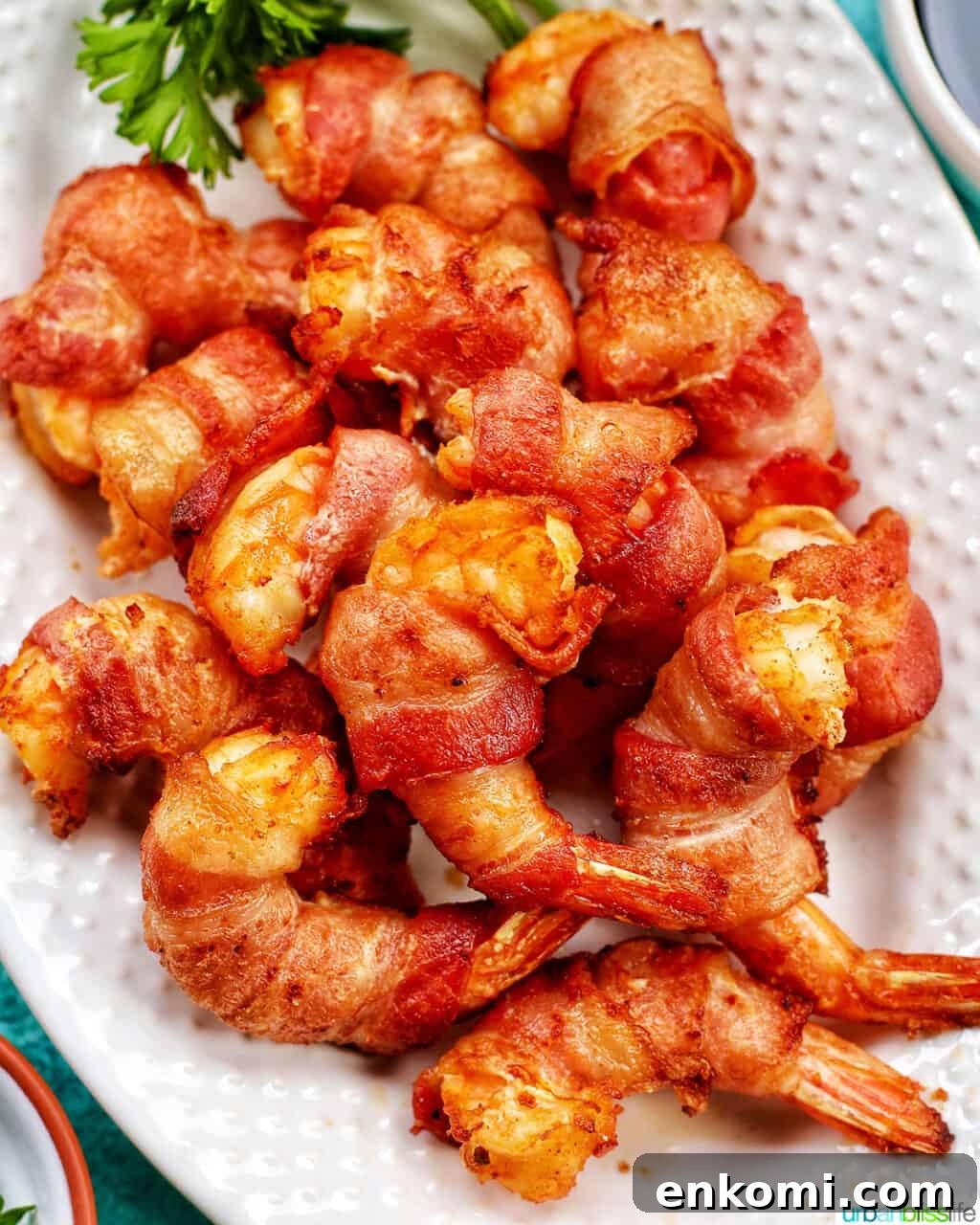 Crispy Air Fryer Bacon-Wrapped Shrimp Recipe 2 air fryer bacon wrapped shrimp on a plate FEATURE