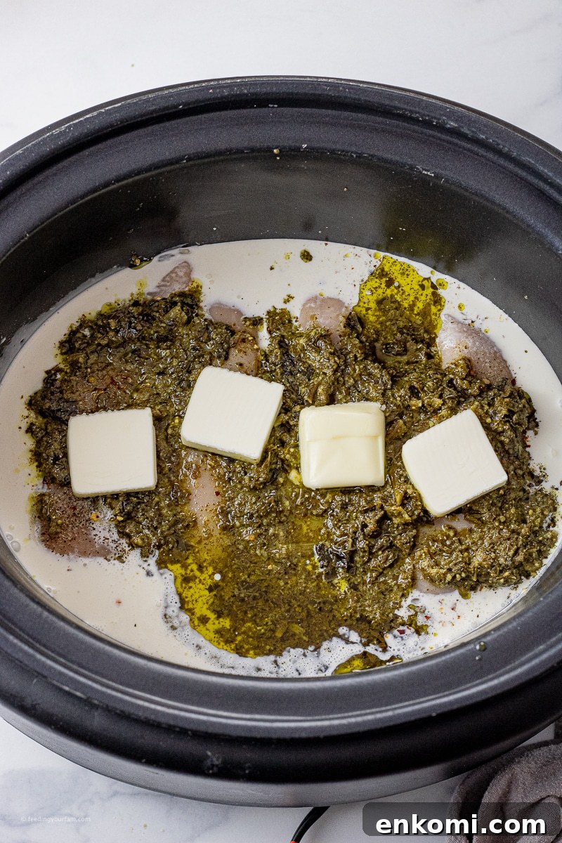 Slow Cooker Pesto Chicken Recipe for Tender, Flavorful Meals 3 chicken, pesto, cream, butter and broth in a slow cooker pot