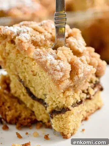 A fork is going through a piece of the sourdough coffee cake.