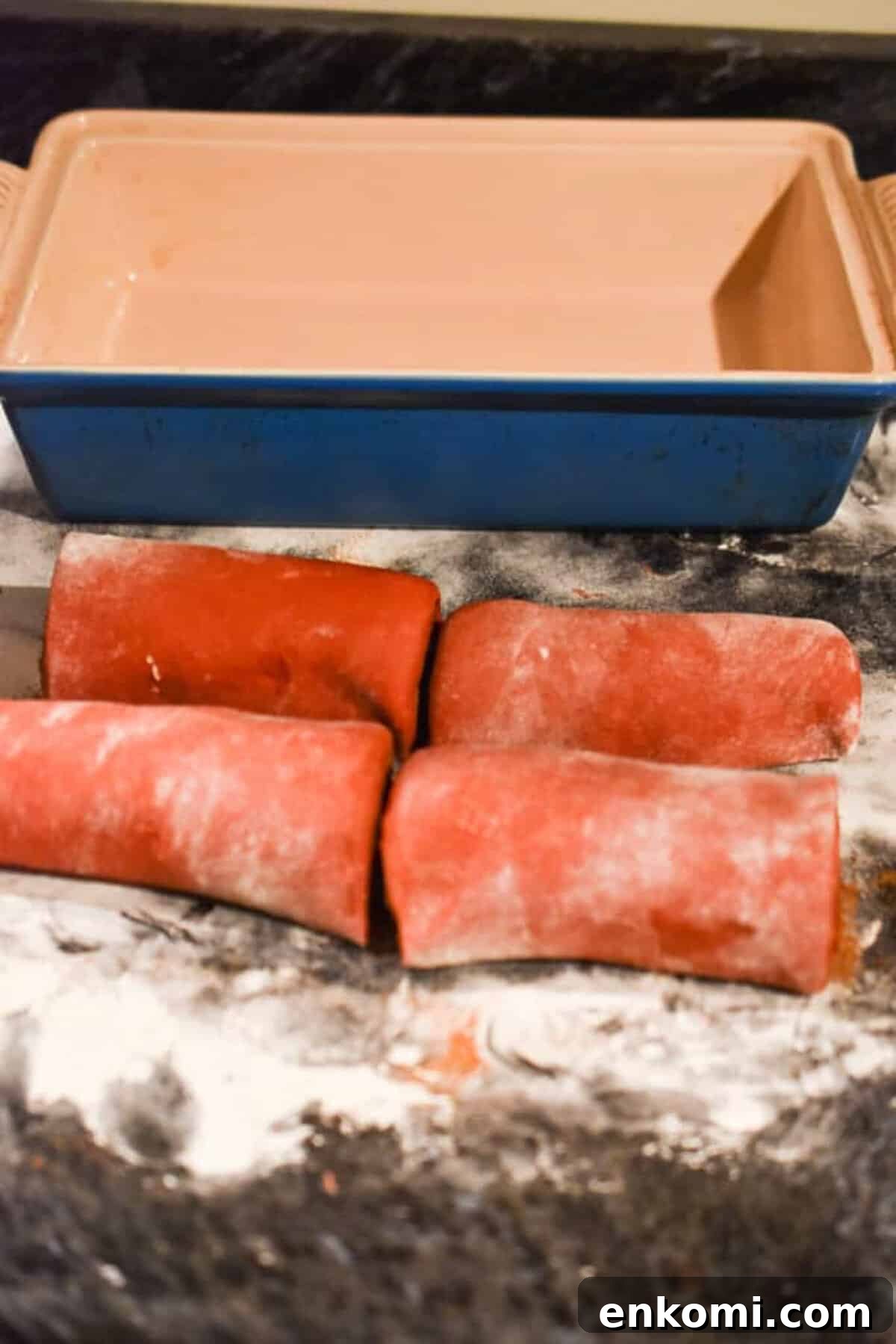 Homemade Red Velvet Cinnamon Rolls with Cream Cheese Glaze 5 The dough is cut into four sections.