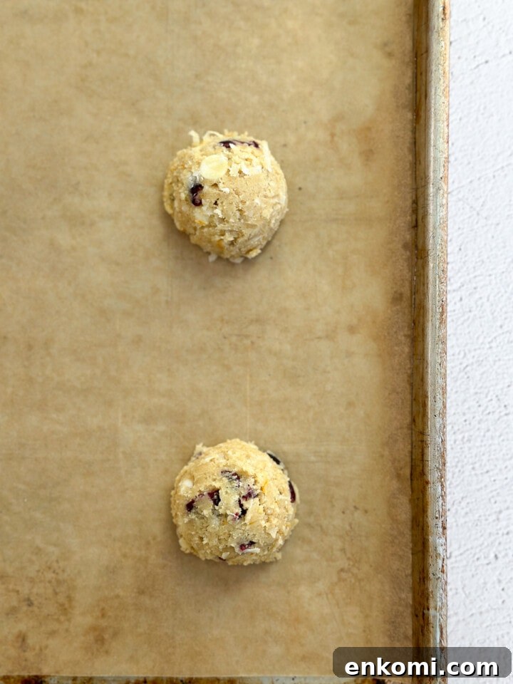 White Chocolate, Cranberry & Orange Cookies — Holiday Citrus Treats 11 cookie dough on a baking sheet before baking.