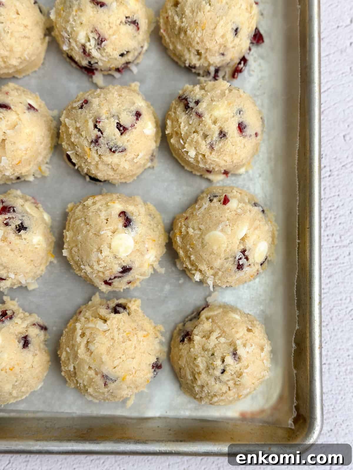 White Chocolate, Cranberry & Orange Cookies — Holiday Citrus Treats 14 a bunch of the white chocolate orange cranberry cookie dough lined up.