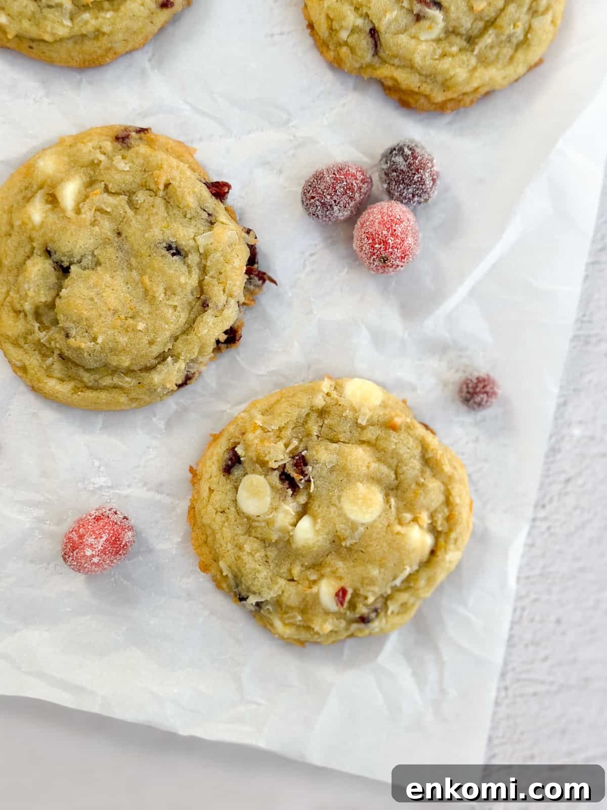 White Chocolate, Cranberry & Orange Cookies — Holiday Citrus Treats 3 a close up of two white chocolate orange cranberry cookies.