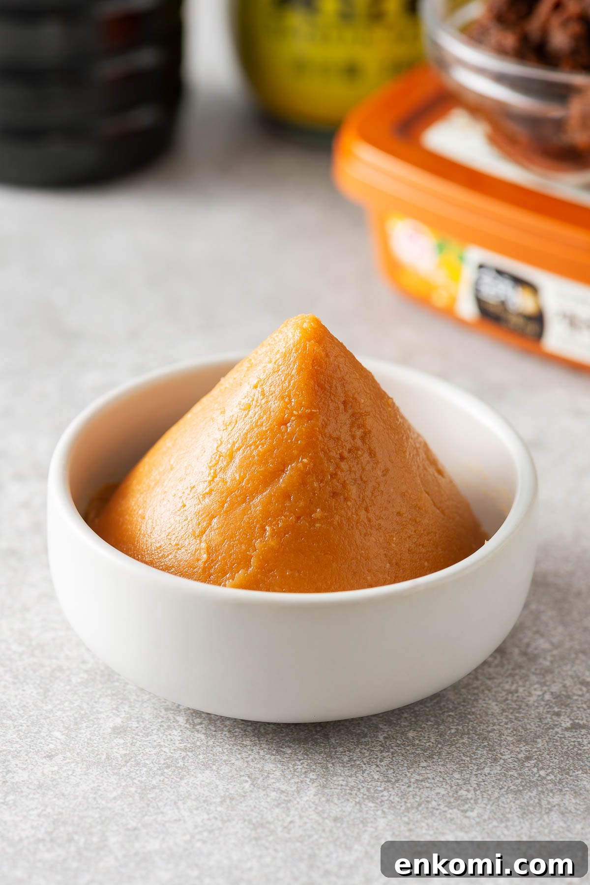 Miso Substitutes and Alternatives: What to Use — and What to Avoid 3 Miso paste in a bowl with some miso substitutes in the background.