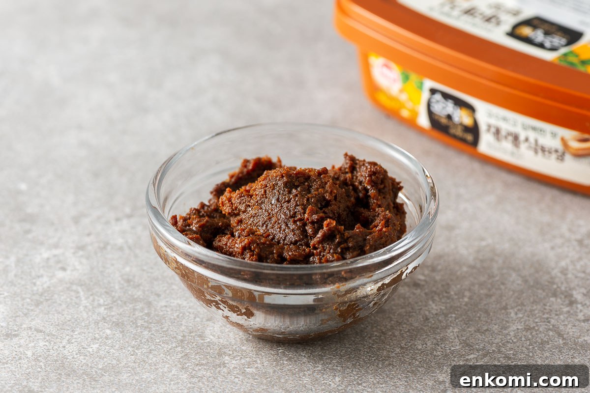Miso Substitutes and Alternatives: What to Use — and What to Avoid 7 Doenjang in a small glass bowl with a deep brown colour.