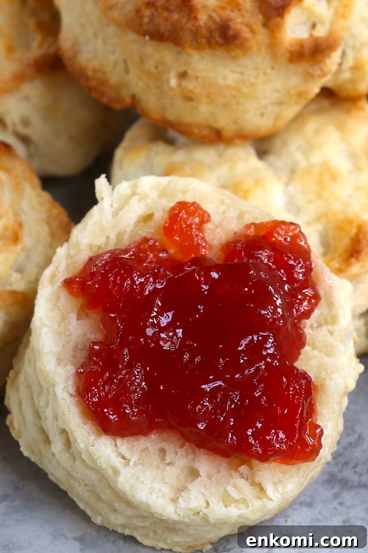 Popeyes-Style Buttermilk Biscuits: Copycat Recipe for Flaky Biscuits 8 Freshly baked popeyes biscuits served with jam.