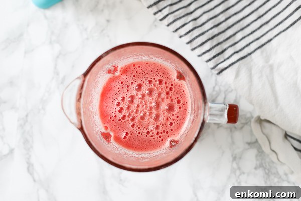 watermelon mixture in blender with a stripped towel