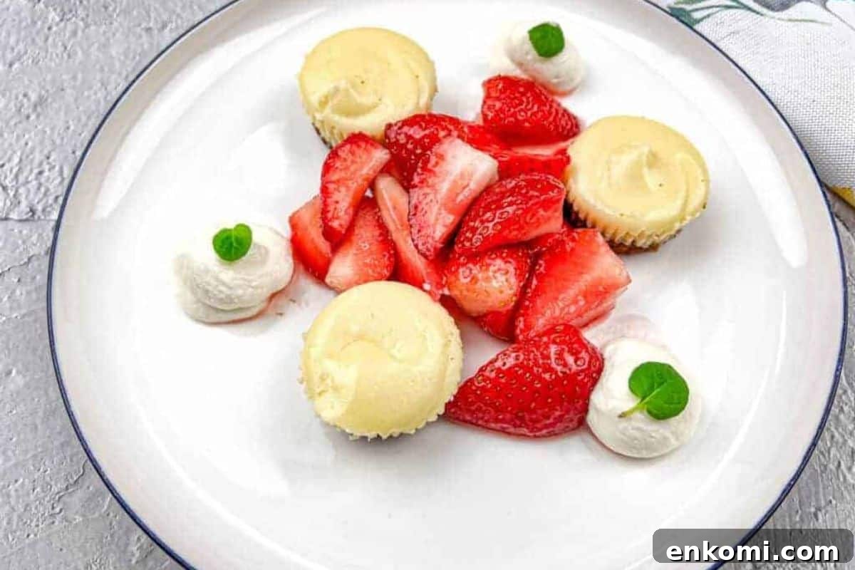 29 Fall Desserts That Bring Generations of Flavor Together 12 A white plate with strawberries and mini biscoff cheesecakes.