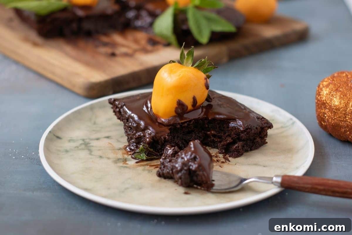 29 Fall Desserts That Bring Generations of Flavor Together 14 A piece of Pumpkin Patch Brownie Cake on a plate with a fork.