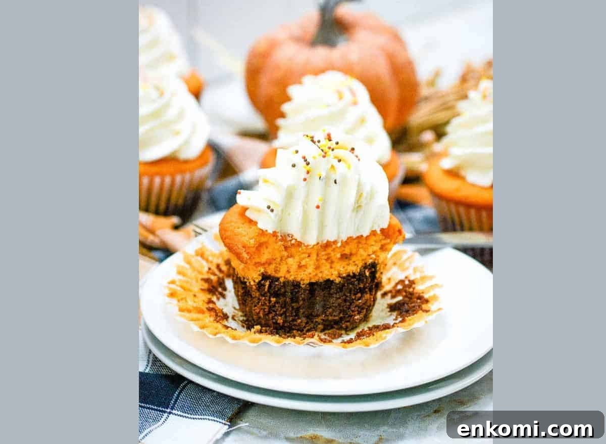 29 Fall Desserts That Bring Generations of Flavor Together 17 Fall brownie cupcakes with whipped cream on a plate.