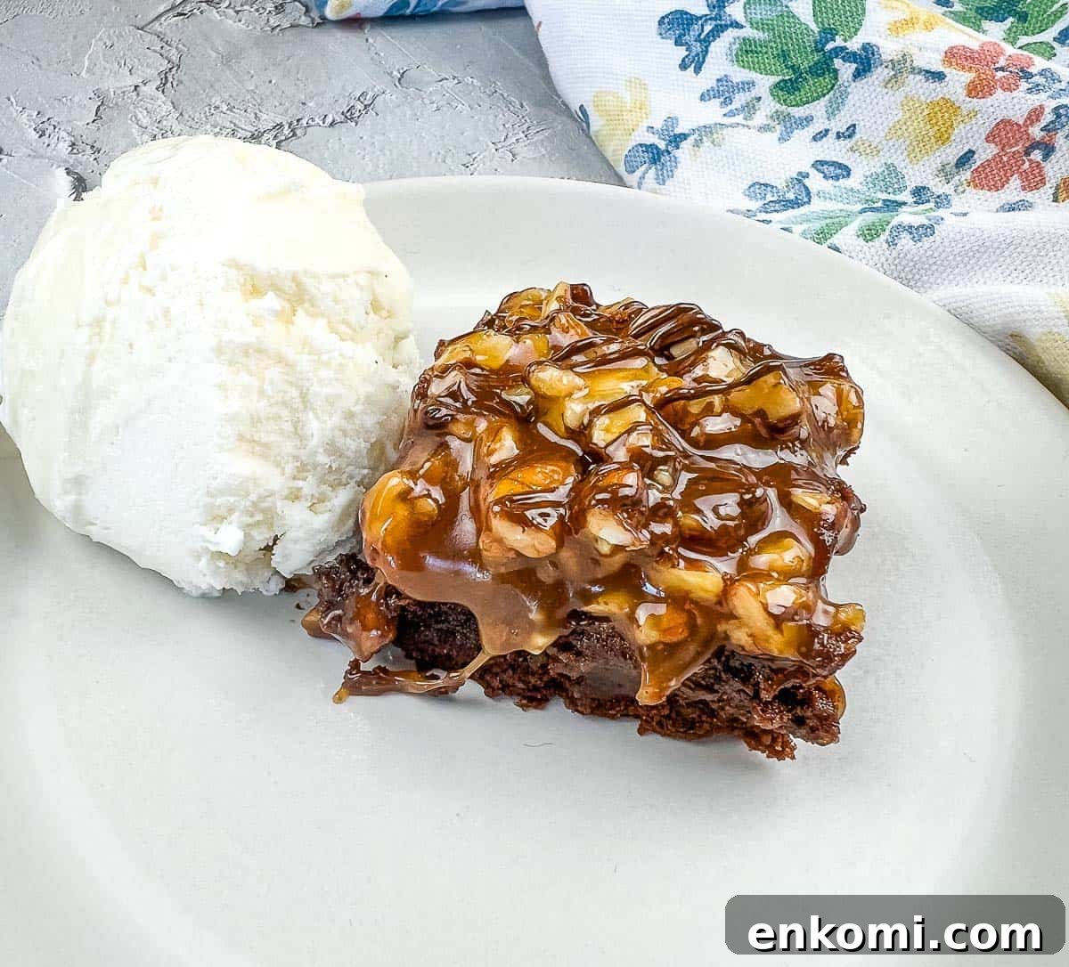 29 Fall Desserts That Bring Generations of Flavor Together 18 A piece of Turtle Brownie with ice cream on a plate.