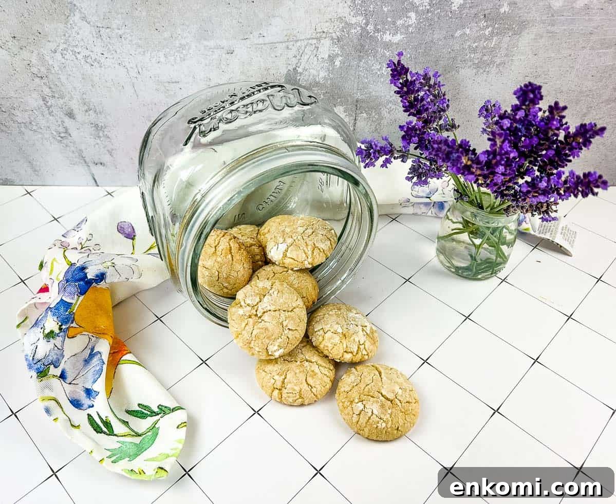 29 Fall Desserts That Bring Generations of Flavor Together 25 A jar of White Chocolate Crinkle Cookies next to lavender flowers.