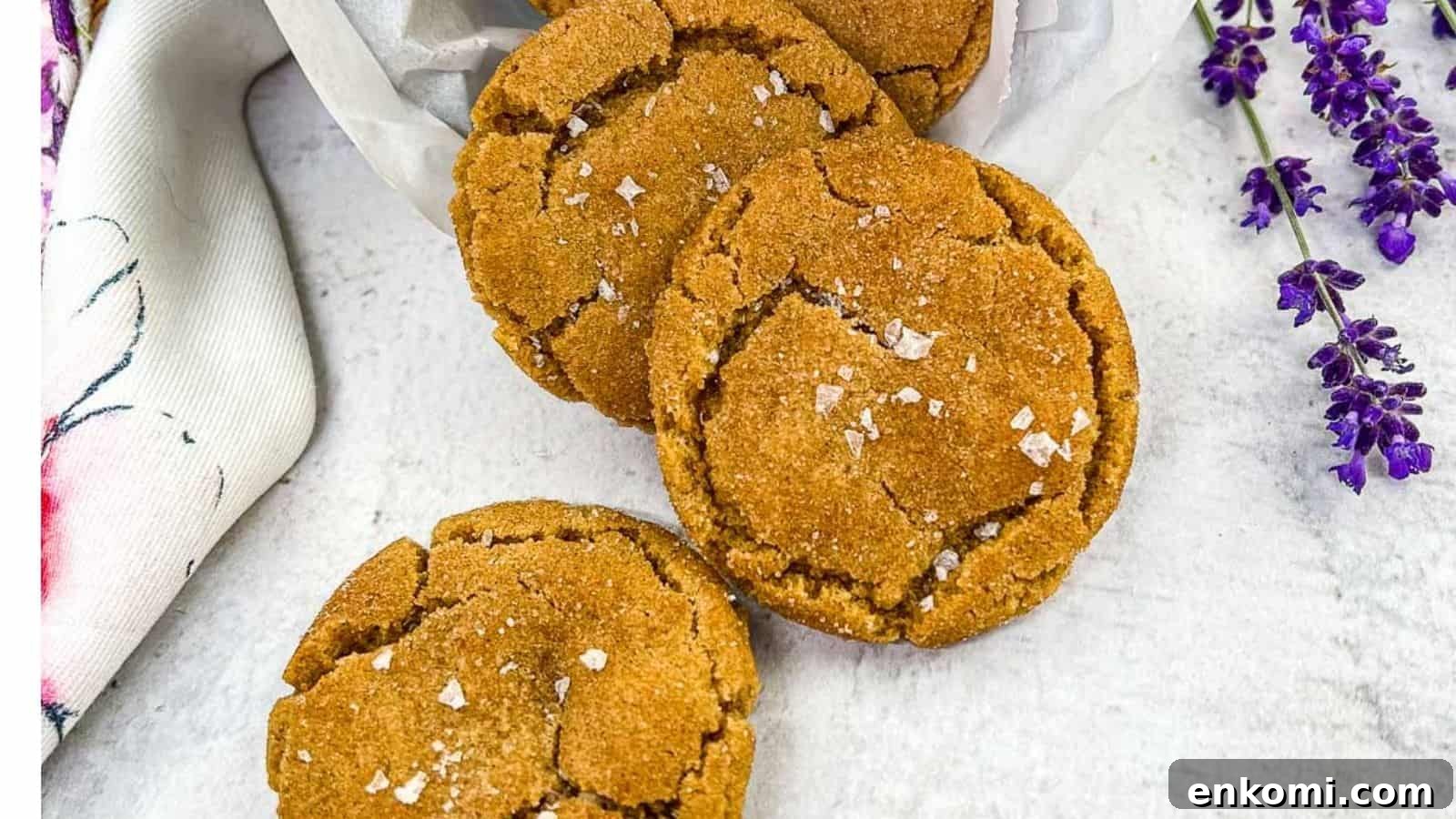 29 Fall Desserts That Bring Generations of Flavor Together 28 Three brown butter snickerdoodle cookies arranged on a white surface, sprinkled with sea salt flakes.