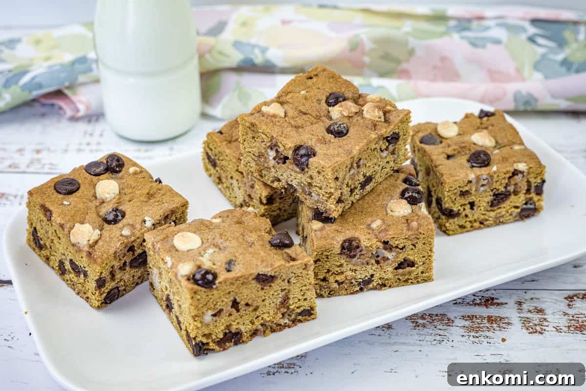 29 Fall Desserts That Bring Generations of Flavor Together 29 A white rectangular plate with pieces of pumpkin blondies.
