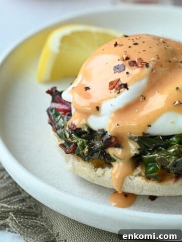 Close-up of eggs Florentine with tomato hollandaise.