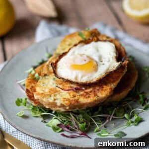 Parmesan, Lemon & Herb Savory French Toast Recipe 16 Angled view of savory French toast with a fried egg on top over greens.